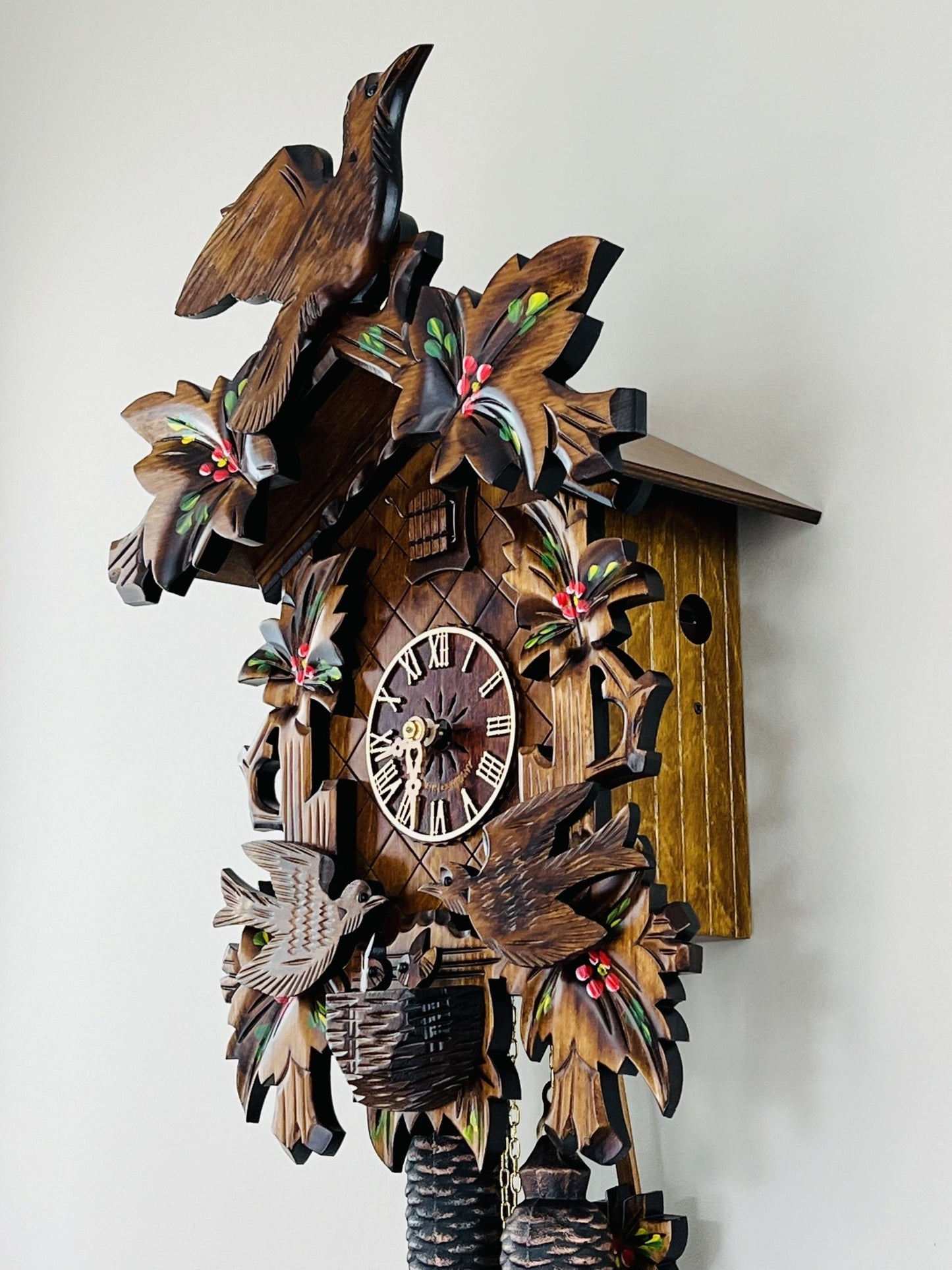 River City Clocks 16" Eight Day Cuckoo Clock with Hand-painted Flowers, Leaves, and Animated Birds Feeding Baby Birds